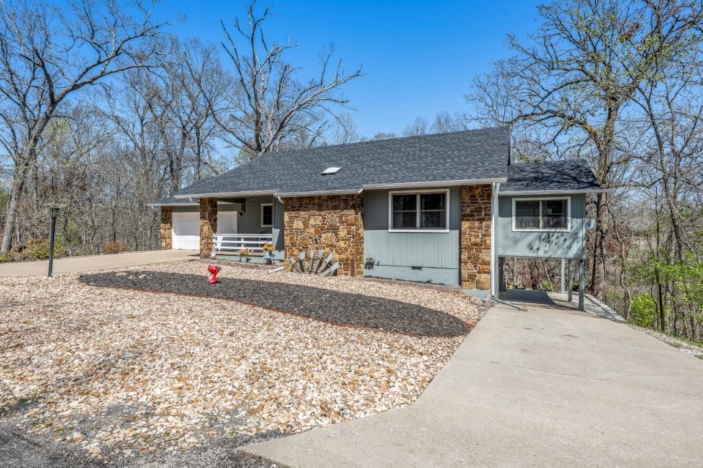Established, well-cared-for home w/ LOTS of charm & updates in a desired Bella Vista Area. This home boasts a new roof, HVAC system, water heater, flooring, Interior & Exterior paint, appliances, & fixtures. Offering 3 spacious bedrooms, including a bonus suite in the walkout basement featuring its own full bathroom & entrance. Engineered hardwood floors, granite countertops are just a few amenities; all sitting on a .50-acre lot. Enjoy additional features like a beautiful sunroom, a covered front patio, a rear deck, two driveways, a full 2-car garage, & a covered carport for a third vehicle. The peaceful backyard is shaded by a beautiful canopy of trees. Conveniently located near Branchwood Park, Highlands & Scotsdale Golf Course, Loch Lomond, Bella Vista gun range, & MORE.