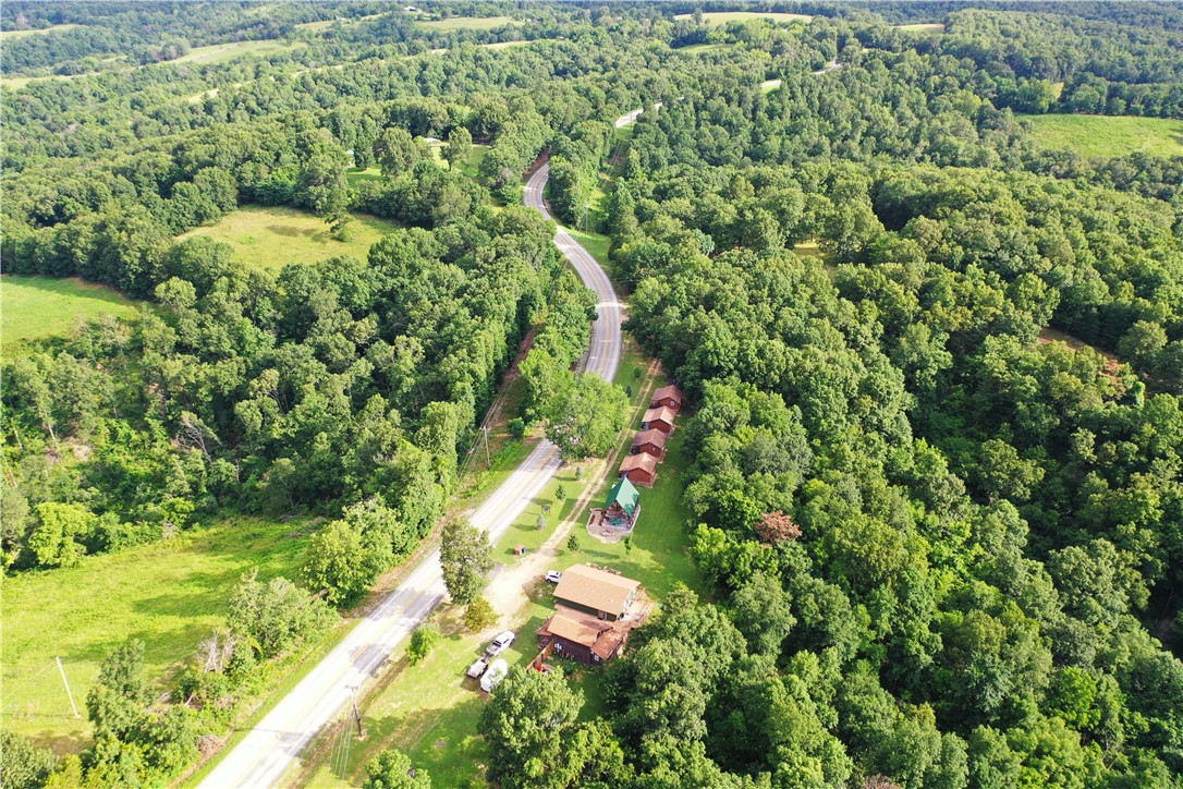 TRULY A DIAMOND GEM OF A RESORT LOCATED IN THE OZARK MOUNTAINS. ONLY A FEW MINUTES FROM THE FAMOUS BUFFALONATIONAL RIVER. WHERE YOU CAN ENJOY FISHING, FLOATING, AND HIKING FOR MILES AROUND. THIS POPULAR RESORTHIDEAWAY HAS BEEN COMPLETELY UPDATED INSIDE & OUT WITH AMAZINGLY DETAILED WORKMANSHIP, INCLUDING THECABINS, MAIN HOUSE, & LARGE PAVILION FOR THE GUESTS TO ENJOY WHILE GUESTS STAY. THEY CAN HIKE AND EXPLORE THE17 WOODED ACRES LOCATED BEHIND THE CABINS, OR JUST TAKE IT EASY ON THE COVERED & OPEN DECKS, OR THE PAVILION,AFTER A FUN FILLED DAY AT THE BUFFALO RIVER. THIS PROPERTY IS A TURN-KEY RESORT WAITING FOR A NEW OWNER.EXPLORE ALL THE UPSIDE POSSIBILITIES THE RESORT HAS TO OFFER.