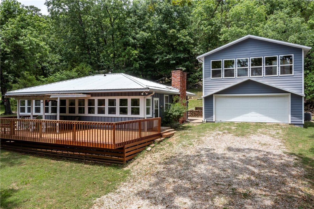 Beaver Lake Front Lot with Boat Dock located at the end of a no-thru street with seasonal waterviews. This 1976 1-story, frame sided home (2-beds,2-3/4bths,1200sqft) & apartment (1-bed,1-3/4bth,720sqft) is located above 2-car oversized detached garage. Totaling 1,920sqft of living space. Open living/dining/kitchen area and many windows on lakeside allowing natural light in both spaces, large main bedroom with 2-closet areas and small private bath. Level front yard that gently slopes down to a short walk to dock & swim deck, backyard patio w/rockwall then steps up towards back deck access to apartment, backyard slopes upward to back of scenic lot in the trees. Picturesque setting on a quiet part of the lake. Updates: some remodel in main kitchen 2008, metal roofs 2012, garage/apartment 2012, main front deck 2021. Conveys: all furnishings are included along w/2-fridges, 2-stove/ovens, 2-dishwashers, 2-microwaves, 1-washer/dryer, outdoor shed for lawn stuff, community boat dock w/2-boat slips/swim deck/1-boat lift.