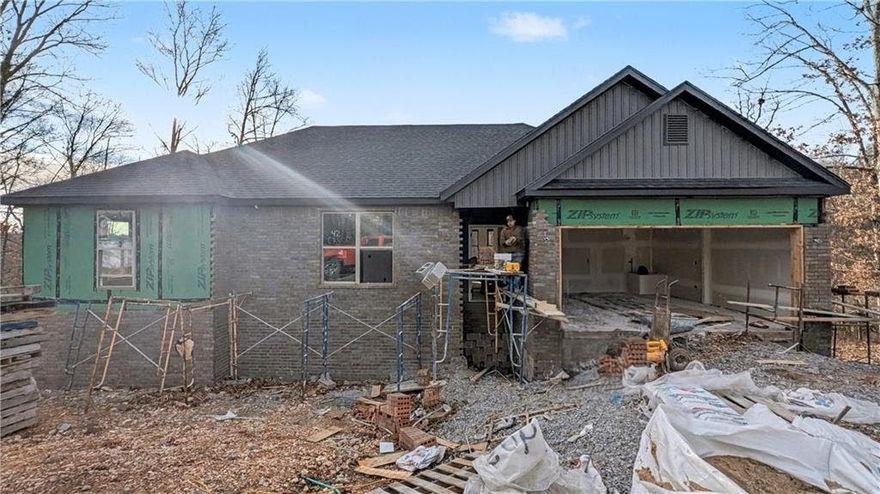 Welcome To Your Next Home! Zoned For Bentonville Schools And Surrounded By Some Of The Best Mountain Bike Trails In Bella Vista, This One Nails The Sweet Spot Between Location, Layout, And Lifestyle. Step Inside To 9 Ft Ceilings, A Bright Open Living Area, And A Super Functional Floorplan That Makes Easy Furniture Placement A Total Breeze. The Corner Fireplace Sets The Mood, While The Kitchen Brings The Heat With Custom Cabinets, Granite Counters, Tile Backsplash, Under-Cab Lighting, Pantry Storage, Island Seating, And A Sunny Eat-In Dining Area. The Primary Suite Is Built For Real-Life Comfort With A Walk-In Closet, Soaker Tub, Tile Shower, And Dual Vanity. Two Secondary Bedrooms + A Full Hall Bath With Double Vanity Give Everyone Space To Spread Out. Out Back, Enjoy A Covered Deck Overlooking A Fresh, Sodded Yard—Perfect For Weekend Grilling, Morning Coffee, Or Post-Ride Relaxing. This Floorplan Just Works, And This Location Is Hard To Beat! Wrapping Up Jan/Feb. Still Time To Make Interior Selections