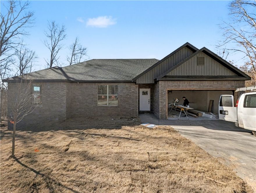 Welcome To Your Next Home! Zoned For Bentonville Schools And Surrounded By Some Of The Best Mountain Bike Trails In Bella Vista, This One Nails The Sweet Spot Between Location, Layout, And Lifestyle. Step Inside To 9 Ft Ceilings, A Bright Open Living Area, And A Super Functional Floorplan That Makes Easy Furniture Placement A Total Breeze. The Corner Fireplace Sets The Mood, While The Kitchen Brings The Heat With Custom Cabinets, Granite Counters, Tile Backsplash, Under-Cab Lighting, Pantry Storage, Island Seating, And A Sunny Eat-In Dining Area. The Primary Suite Is Built For Real-Life Comfort With A Walk-In Closet, Soaker Tub, Tile Shower, And Dual Vanity. Two Secondary Bedrooms + A Full Hall Bath With Double Vanity Give Everyone Space To Spread Out. Out Back, Enjoy A Covered Deck Overlooking A Fresh, Sodded Yard—Perfect For Weekend Grilling, Morning Coffee, Or Post-Ride Relaxing. This Floorplan Just Works, And This Location Is Hard To Beat! Wrapping Up Jan/Feb. Still Time To Make Interior Selections