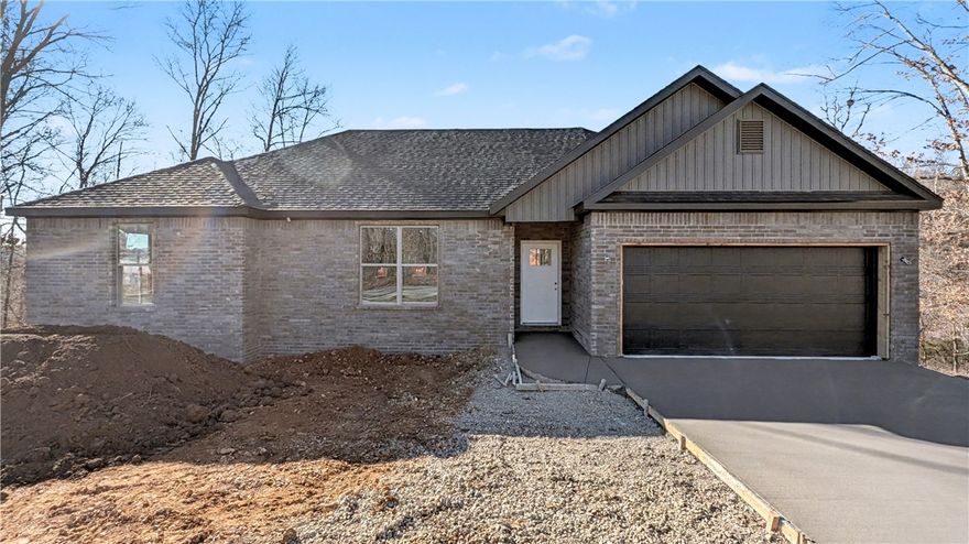 Welcome To Your Next Home! Zoned For Bentonville Schools And Surrounded By Some Of The Best Mountain Bike Trails In Bella Vista, This One Nails The Sweet Spot Between Location, Layout, And Lifestyle. Step Inside To 9 Ft Ceilings, A Bright Open Living Area, And A Super Functional Floorplan That Makes Easy Furniture Placement A Total Breeze. The Corner Fireplace Sets The Mood, While The Kitchen Brings The Heat With Custom Cabinets, Granite Counters, Tile Backsplash, Under-Cab Lighting, Pantry Storage, Island Seating, And A Sunny Eat-In Dining Area. The Primary Suite Is Built For Real-Life Comfort With A Walk-In Closet, Soaker Tub, Tile Shower, And Dual Vanity. Two Secondary Bedrooms + A Full Hall Bath With Double Vanity Give Everyone Space To Spread Out. Out Back, Enjoy A Covered Deck Overlooking A Fresh, Sodded Yard—Perfect For Weekend Grilling, Morning Coffee, Or Post-Ride Relaxing. This Floorplan Just Works, And This Location Is Hard To Beat! Wrapping Up Jan/Feb. Still Time To Make Interior Selections