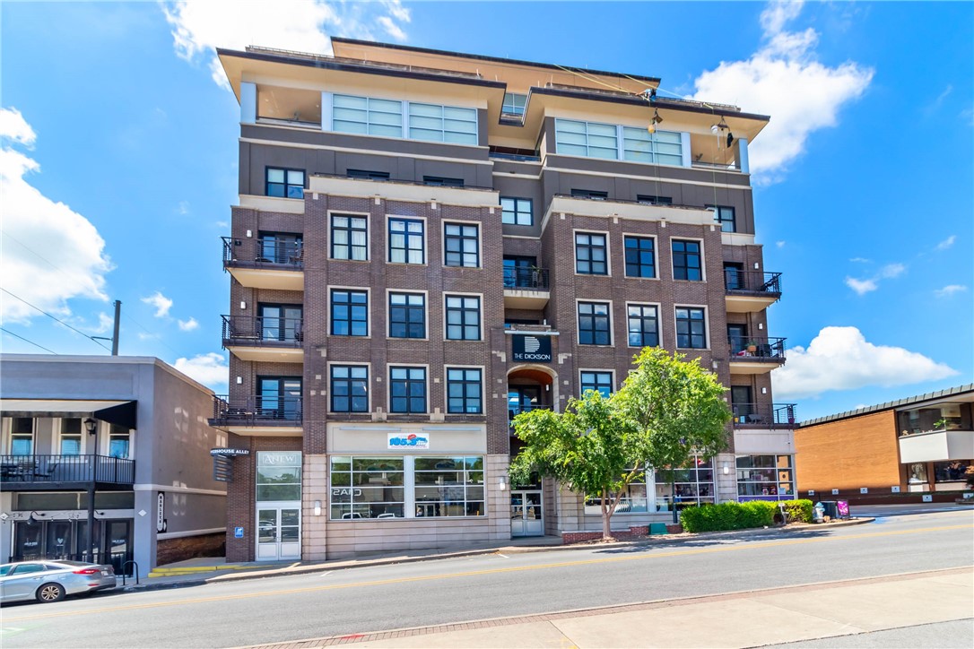 Experience the ultimate in urban convenience & Razorback charm with this beautifully appointed 2-bedroom, 2-bath condo in The Dickson — Fayetteville’s premier downtown building. Perfectly positioned adjacent to the University of Arkansas campus & located directly on iconic Dickson Street, this residence places you steps away from the city’s best dining, entertainment, & campus events. Enjoy breathtaking, east-facing views that capture the beauty of the Fayetteville Square & Mt. Sequoyah, filling your space with natural light & scenic skyline mornings. Inside, the open-concept layout offers modern finishes, a spacious kitchen, & a private balcony to soak in the view. Residents benefit from secure access, elevators, & the convenience of a connected parking garage with available leased spaces. Whether you’re looking for a game-day getaway, a full-time residence, or a lock-and-leave lifestyle in the heart of town, this condo delivers style, comfort, & unbeatable location in one of Fayetteville’s most coveted addresses.