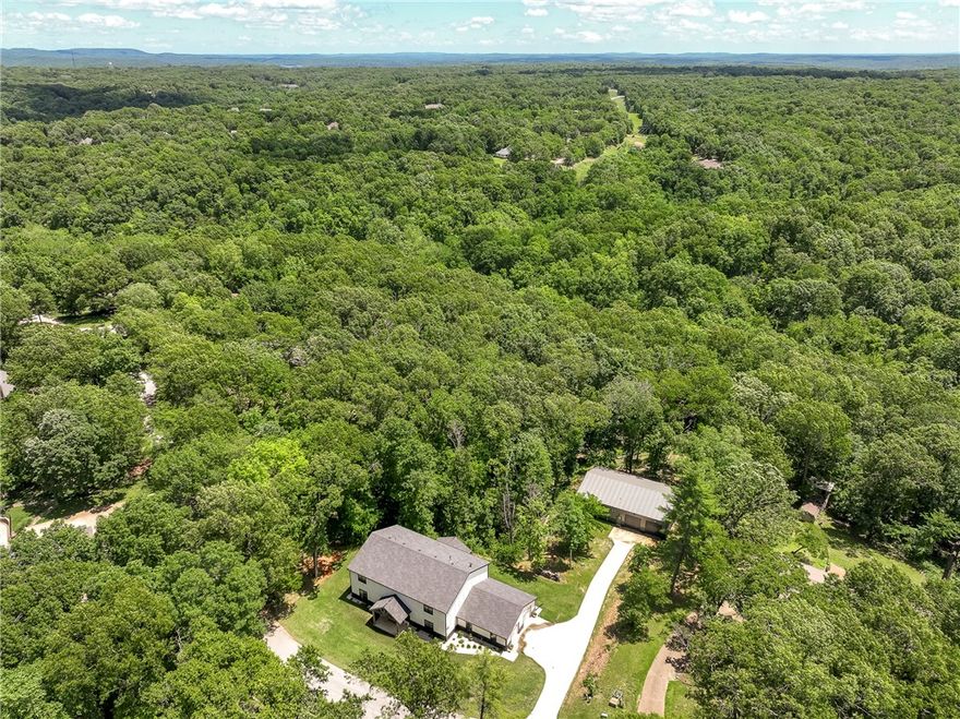 HYLAND PARK — Contemporary Farmhouse on 2+ Acres with Workshop.
Welcome to this beautiful, modern farmhouse in the heart of Rogers—just minutes from downtown and Prairie Creek Boat Dock. Situated on over 2 acres, this home offers a perfect blend of comfort and style. Enjoy the open-concept layout with a spacious kitchen, walk-in pantry, commercial Frigidaire appliances, large island, and breakfast bar. The cozy living and dining areas are ideal for entertaining. The primary suite features a soaking tub, large shower, and walk-in closet connected to the laundry room. There's also a guest bedroom on the main level. Upstairs offers a media room, Jack-and-Jill bath, and more bedrooms. Step outside to a covered patio and an incredible 40x60 workshop with an in-law apartment and full kitchen. Endless possibilities for families, hobbyists, and entertainers.
