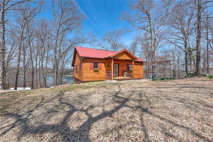 Experience exceptional year-round lake views from every room in this thoughtfully-designed custom build. A community boat ramp is just minutes away, & mountain biking trails are nearby. This pristine home is situated on a serene 1.02-acre lot and features an abundance of natural light, split floorplan, & open concept. Entry opens to beautiful hardwood floors in the Kitchen, Eat-in Area, & Family Room. New s/s kitchen appliances add a fresh, modern touch, in addition to a spacious walk-in pantry & second refrigerator. Retreat to the primary suite featuring a beautifully tiled accessible walk-in shower, generous storage, & a laundry room for convenience. Designed for hosting guests, entertaining, or multi-generational living, the fully-finished walkout basement features an additional BR, Full BA, & a generous Bonus Room with bar seating & mini fridge. A 12'x20' storage bldg. w/loft provides addt'l space for lawn equipment. The covered deck & patio invite you to unwind, recharge, & truly experience the lake lifestyle.