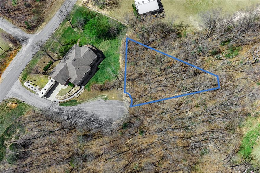 Tucked at the end of a peaceful cul-de-sac on Askew Lane, this 0.24-acre wooded lot in Bella Vista's Croydon subdivision is your chance to build something special. The gently sloping, tree-lined terrain provides privacy and natural charm at an incredibly accessible price — just $19,000 with annual taxes of only $53. Electricity runs to the street, public water is available, and a private septic system will be needed. As a Bella Vista POA member at just $16/month, you'll enjoy an extraordinary lifestyle: 7 golf courses, 7 private stocked lakes, 100+ miles of hiking and biking trails, swimming pools, tennis courts, fitness centers, a gun range, and parks throughout the community. This is NW Arkansas living at its finest.