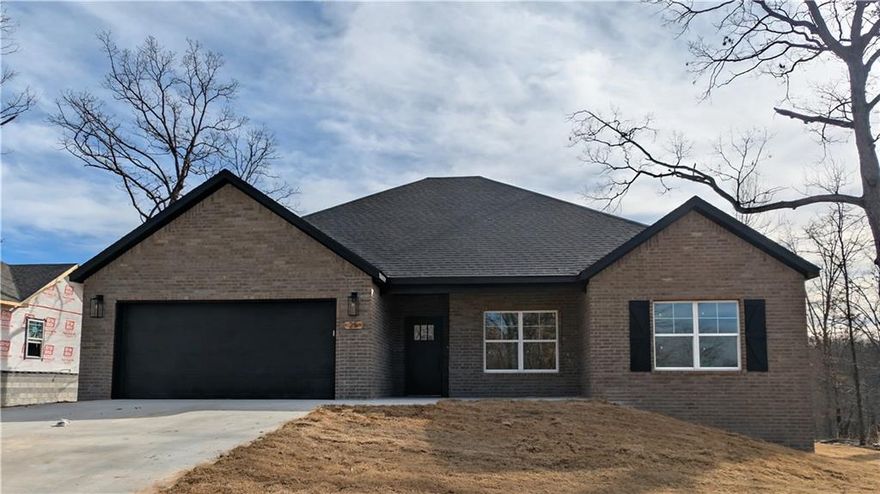 This beautiful 3 bedroom, 2 bath new construction home offers modern comfort and style on a highly sought-after flat back yard. Inside, the open living area features vaulted ceilings, abundant natural light, and a striking floor-to-ceiling stone fireplace with a rustic wood mantel that serves as a warm focal point.  A well-designed split floorplan offers privacy and flow, complemented by granite countertops, a gas stove, spacious walk-in closets, and a convenient pantry for modern living.  Durable wood-look tile flooring adds contemporary character while offering easy maintenance, and the neutral color palette creates a bright, welcoming atmosphere. Thoughtful finishes and quality craftsmanship throughout make this home ideal for comfortable everyday living as well as effortless entertaining.