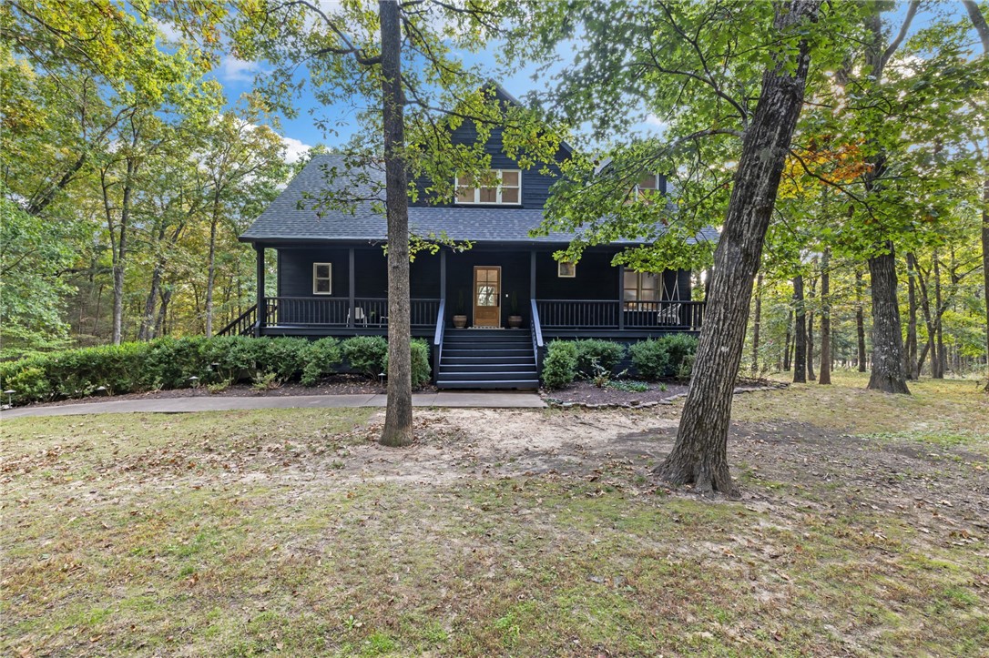 Experience the peacefulness of established acreage right in town. This impeccably updated 3 bed, 2 bath Fayetteville home sits on nearly eight private acres surrounded by mature trees and natural beauty. Inside, high ceilings and large windows fill the home with natural light, while hardwood floors and modern finishes create a warm, inviting feel. The beautifully refreshed kitchen opens to a generous living space, the home also has a second distinct living area that offer flexibility for gathering or quiet retreat. Multiple covered patios, an outdoor fire pit, and open green space make outdoor living effortless. Just minutes from the University of Arkansas and Downtown Fayetteville, this move-in ready home offers the perfect blend of privacy, modern updates, and convenience.