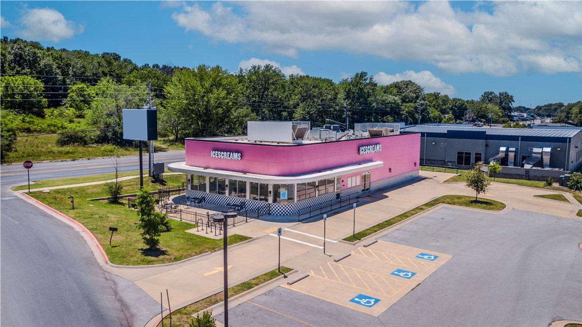 Rare opportunity to own/lease prime real estate in west Fayetteville. Building is currently finished out for a restaurant, but has potential to be remodeled to suit multiple other uses. With frontage along Hwy 62, property is minutes from I-49, the U of A, and Farmington. Building features beautiful windows wrapped around a large dining area or showroom. Vent hoods, grease trap, & walk-in cooler installed. Kitchen equipment and restaurant furnishings negotiable. Lot includes drive-thru & 65 parking spaces. Adjacent to Club Car Wash with 37,000 CPD along Hwy 62.
