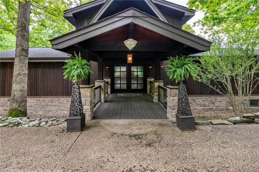 Looking for a slice of paradise with a private boat dock, acreage & two master suites? Marvel at this fully remodeled Stitt built energy efficient luxury lakefront home nestled in a private cove. Enter through the iron front doors, noting the floor to ceiling windows & stone fireplace. Venture to the chef’s kitchen with Miele appliances & corian island. Meander to the main level master suite with custom textured flooring, exposed beams & en suite bath. Travel the marble staircases to either a spacious office loft or custom bar w/ drawer cooler systems, wine storage, ice maker & Brookhaven oak cabinetry. The 2nd level master reveals expansive natural lighting. Other amenities: individual hers vanities & a walk in closet w/ such vast storage it could hold Imelda Marcos’ shoes. The en suite bath- his vanity & floor to ceiling marble shower. Venture outside for the beautiful lake view. Relax on the 3 seasons porch or over 580sq ft of multi-level decking. Walk down the well-lit path & arrive at the private 2 slip dock.