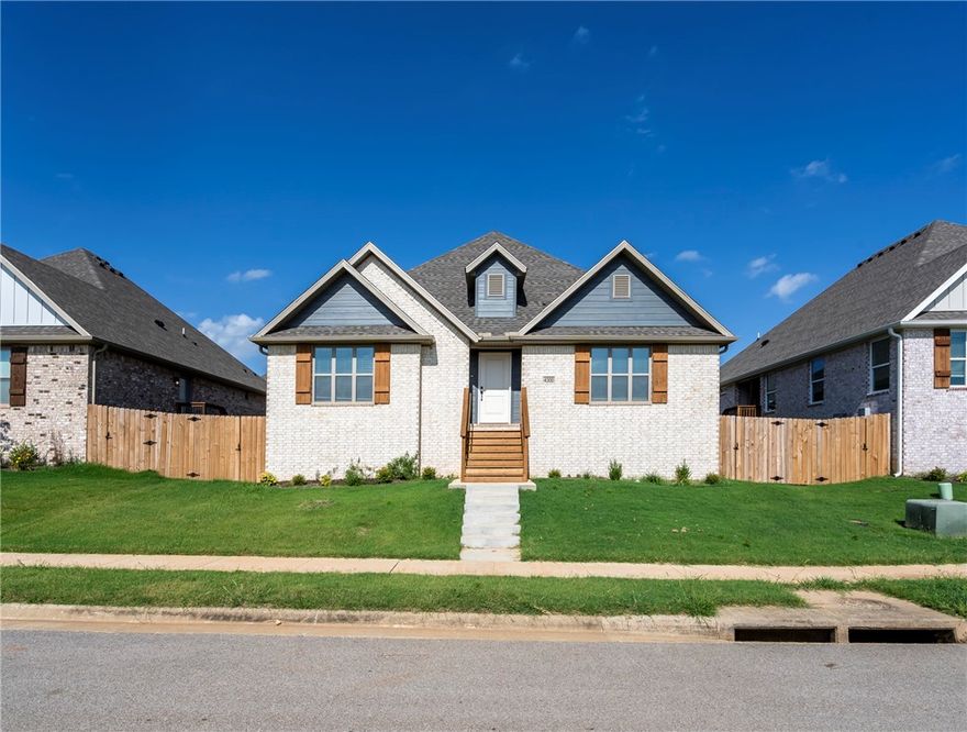 This well-crafted home offers curb appeal and comfort in equal measure, showcasing a brick exterior with wood accents and a welcoming front entry. Step inside to a bright, open living space featuring warm wood-look tile floors, tray ceilings, and a sleek gas fireplace. The kitchen is a true centerpiece, equipped with a center island, granite countertops, stainless steel appliances including a gas range, and ample cabinet storage plus a pantry. The spacious primary suite includes a serene bedroom with a trey ceiling and an en-suite complete with a large tiled shower and double vanities. Enjoy outdoor living with a fenced yard, covered side porch, and a rear-entry two-car garage. Perfectly situated in a vibrant neighborhood—this home blends comfort and convenience with modern finishes throughout.