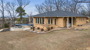 Welcome to the distinctive characteristics of this 2350 ft. three bedroom two full bath home on 41 acres minutes from Clarksville city limits Makes this a one of a kind property. Sun-drenched rooms with expansive mountain views overlook a large covered porch with several decks, a semi inground Burton sport pool ,Hot tub and 16 x 30 boat/RV garage with 12 x 12 drive through doors, separate garage includes a two piece bathroom and Tornado safe room. The fenced acreage is ready for livestock of your choosing with a pond and a creek at their reach. The home features a new roof hardwood flooring throughout a new luxurious kitchen with custom cabinets, new appliances, quartz countertops and a large butcher block island.This property has a park like setting with its own fruit orchard. Lovely!