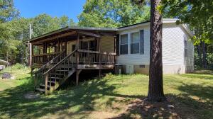 Quiet, clean and serene describe this piece of property and home, just 24 minutes from Harrison and 25 minutes to Branson in the Omaha, AR area. This 2006 Cavalier manufactured home sits on 5.51 acres, and has been meticuliously cared for. New roof installed in 2020. New heat pump installed in 2021. Propane backup. Tank is owned and conveys. Handicap Accessible. 12x24 rear deck. Omaha water, Natco Internet. Trash pickup paid for thru the end of the year. All appliances and items in the home convey with the property. 12x16 Metal shop/storage with power. 12x20 Carport.