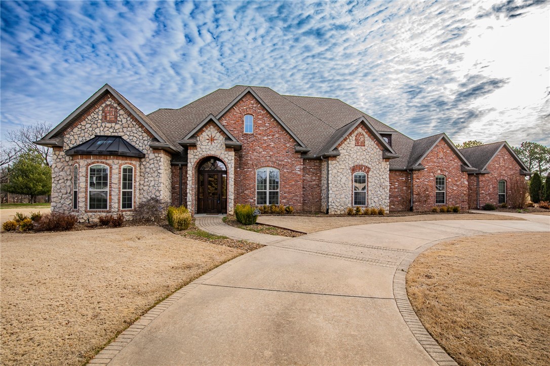If you're looking for the perfect country home that offers both privacy and convenience, look no further than this gem. On 1.65 acres of pristine land in a quiet cul-de-sac, this home offers the perfect blend of country living while being minutes from downtown Rogers and Bentonville. As you drive up the circular driveway, you are immediately struck by the serene surroundings and the breathtaking views of the rolling pastures. Step inside and you'll be greeted by the warmth of the wood floors and the natural light that floods the space. The formal dining room and eat-in kitchen make entertaining a breeze. The bonus room and media room are perfect for movie nights and family gatherings, while the safe room offers peace of mind. The spacious bedrooms offer relaxation and rest, and the master suite is a true oasis. The highlight of this home is undoubtedly the stunning views that can be enjoyed from every window. This home has it all!