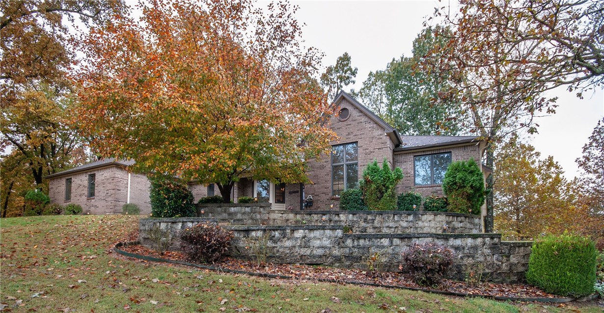 Beautiful Mountain Lake Estate property nestled in the Ozark Mountains. 4 bed, 3.5 bath in Rogers on clear, wooded lot with 2 covered balconies and amazing downstairs entertainment/living quarters. Walk into a spacious open floor plan with large eat-in kitchen. 2-sided fireplace with large dining area with vaulted cathedral ceilings with oak hardwood floors. This property is in a quiet neighborhood steps from Beaver Lake, providing a community dock with fishing and swimming. Large garage and plenty of yard sitting on a large lot. This property is priced to sell.