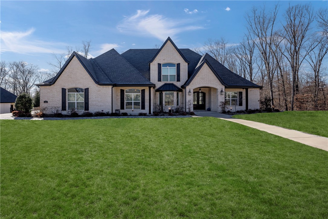 The one that has it ALL. A true 5 bedroom home with 4 of the bedrooms on the main level. This like-new home has gorgeous granite, wood floors, perm. holiday lights, Restoration Hardware lighting, commercial sized refrigerator, drawer microwave and double ovens. The main floor also houses a grand entry, formal dining, living room with beams, breakfast area and dream kitchen. The butler pantry/laundry has many cabinets and large countertop/workspace. Main office close to the primary suite. Every space in this home feels larger than the next.
Upstairs has a media room/living area, a big bedroom, full bath, a second office/work out room/flex area with amazing windows. There is also a walk in attic space. The garage was designed to be 4 car but there is a above ground storm shelter taking up a portion of one of the spaces. The covered back patio has a fireplace and offers a beautiful view of the private back yard and the wooded area behind the home. The lot is larger than the fenced area. Check out the survey.
