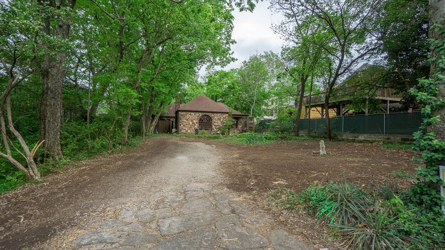 Step into timeless charm at this 1936 stone cottage in Fayetteville’s iconic Wilson Park neighborhood. Just moments from Wilson Park, the University of Arkansas, and vibrant dining, shopping, and nightlife, this 2 bed, 2 bath home offers 1,447 sq ft of character and convenience. A stunning Palladian window welcomes you, admired even by architecture students. Inside, you’ll find beautiful wood floors, original tile accents, and a cozy fireplace with built-in shelving. The dining area opens to one of two private patios surrounded by lush greenery, creating a peaceful, bird-filled retreat. Enjoy your morning coffee on the screened-in porch. Two bedrooms are thoughtfully positioned near the hall bath, while a flexible den off the kitchen includes a second full bath and nearby laundry with patio access. Ideal for walkability to parks, trails, pool, and all Fayetteville amenities—this is a rare opportunity in a highly sought-after location.