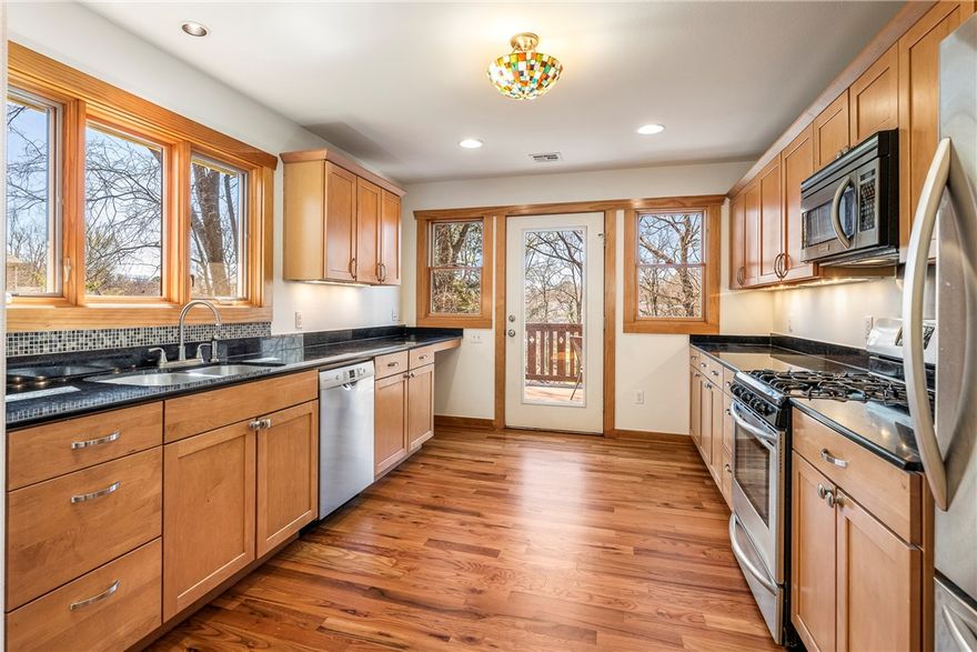 Welcome to turnkey living in the heart of Fayetteville at Wilson Park—this fully renovated, thoughtfully designed home on a larger lot lets you lean into the lifestyle you desire. The home feels like a peaceful sanctuary with welcoming comfort and unbeatable walk-and-bike access to UA, Razorback Greenway, Dickson St, and beyond. The main level lives spaciously with airy open living areas and a private primary suite with a treehouse feel, flowing to a balcony where people naturally linger. The flexible downstairs layout accommodates multiple occupants with a second living area, two bedrooms, an oversized laundry room, and backyard access. A detached storage building adds convenience in place of a garage—perfect for bikes or hobby/sport gear. The large, fully fenced backyard features multiple hangout spaces, including a stone patio with wood-fired pizza oven. Solar panels are fully paid with a transferable net-metering permit. Just minutes to the best of Fayetteville!