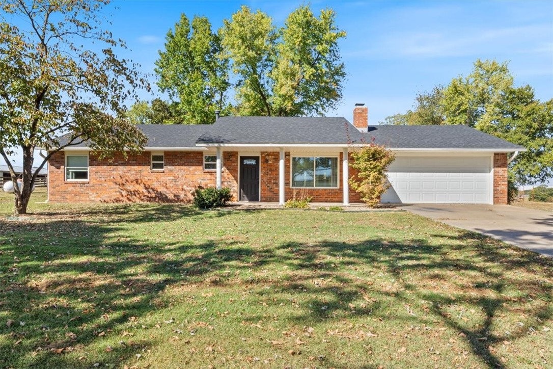 Come home to Prairie Grove! This charming 3 bedroom, 2 bathroom home sitting on 7.63 acres offers the perfect blend of comfort and country living. The spacious kitchen features granite countertops, extra cabinet storage, modern appliances, a pantry and eat in kitchen, making it ideal for both everyday living and entertaining. With the open floor plan comes a spacious living area complete by a wood burning fireplace perfect for the cold winter days curled up on the couch. The primary bedroom is complete with a ensuite bathroom and walk in closet. The built-ins throughout the home add character and functionality. The home also has a generously sized laundry room for added convenience. An brand new roof was just installed! Step outside onto the covered back porch to enjoy stunning views of the expansive property, which includes a barn with stalls, shed, storm cellar, arena and chicken coop. Perfect for those seeking a serene country lifestyle with plenty of space to roam. This home is a must see!