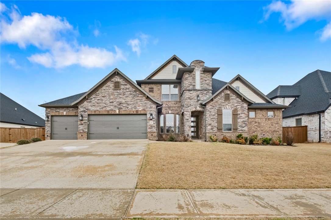 Welcome to this gorgeous, executive home in sought-after Lochmoor Club! This stunning 4 bed, 3.5 bath home is adorned with many elevated features that provide the harmonious blend of comfort and practicality. Features included hardwood floors throughout the home, formal dining, quartz countertops, a gourmet kitchen, large island bar, and more! Bonus room is also featured upstairs. Enjoy trail access right behind the home. In close proximity to Bentonville Community Center, offices, retail, restaurants, XNA, and more. Within less than a half mile of Bentonville Schools