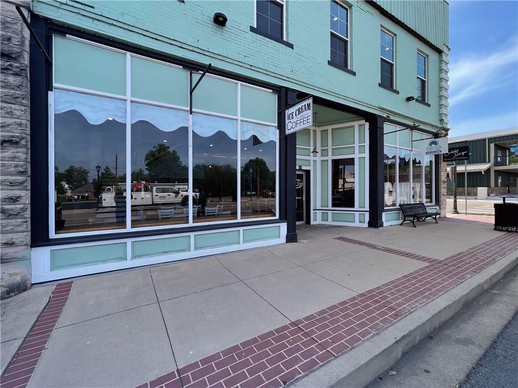 Own a piece of Mena’s vibrant downtown with this beautifully preserved and updated 10,000 sq ft commercial building, ideally located at the base of popular biking trails. This high-visibility corner property features a diverse mix of income-generating spaces. Currently home to four established tenants, the building hosts a retail boutique, dance studio, real estate office, & aesthetician’s boutique. The second floor features a stylish 1,300 sq ft 2 bed/2 bath Airbnb, designed with modern finishes and cozy charm. Guests enjoy a private balcony, relaxing hot tub, & nearby access to biking trails & downtown amenities—earning excellent reviews and consistent bookings. A charming street-facing ice cream parlor is currently set up in the storefront or a new tenant can offer additional revenue potential in a high-foot-traffic area. With strong rental income, historic appeal, & modern upgrades, this unique property offers immediate cash flow & long-term appreciation in one of Arkansas’s most scenic & growing small towns.