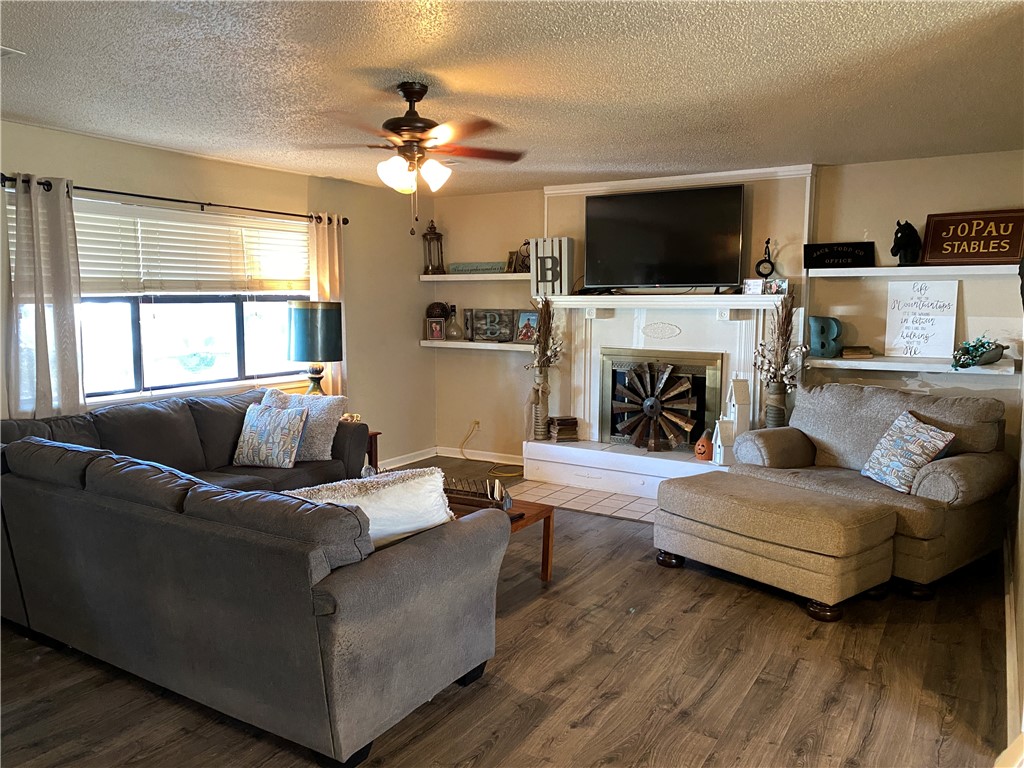 This beautiful home is ready for the next loving family just in time for the upcoming holiday season. The backyard has boasts almost half an acre of entertaining space and a beautiful ivy covered pergola. Mature trees keep the front and back yard shaded year round. Recent updates include updated counters and backsplash, interior and exterior paint, new water heater (2019), a sliding glass door to the backyard, and new flooring in common areas. Current owners are offering a Home Warranty and a $2,000 flooring allowance to allow potential buyers to pick out their choice of carpet in the bedrooms. Come sit around the wood burning fire place and enjoy your new home in Lowell, AR.
