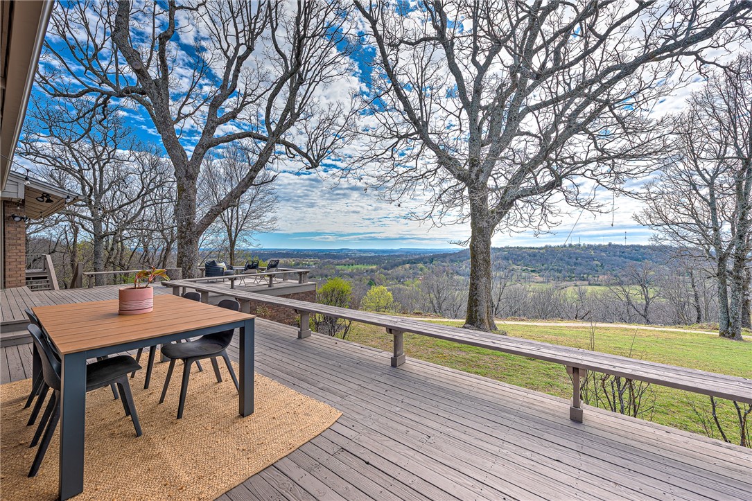 WELCOME TO A ONE-OF-A-KIND CUSTOM-BUILT ESTATE OFFERING ONE OF THE MOST SPECTACULAR VIEWS IN NORTHWEST ARKANSAS!Nestled on a sprawling 3.22 acre setting, this newly remodeled home is situated between historic downtown Springdale and Beaver Lake! Designed by renowned architect Albert Skiles, this architectural masterpiece maximizes natural light and showcases breathtaking panoramic views through expansive floor-to-ceiling windows throughout! A sprawling 2,000 sq ft deck spans the entire back exterior and enjoys the most incredible backdrop! The main level features beautiful open spaces that flow seamlessly providing the ideal setting for entertaining. Large formal dining, fabulous chef’s kitchen with cozy breakfast nook plus a charming hearth room and an open living room w/ cathedral ceilings and dual-sided fireplace. The primary suite is a true retreat w/ 2 luxurious baths, 2 walk-in closets & a gorgeous sunroom with amazing views! Over 600 sq ft in newly finished heated/cooled basement not counted in sq footage.