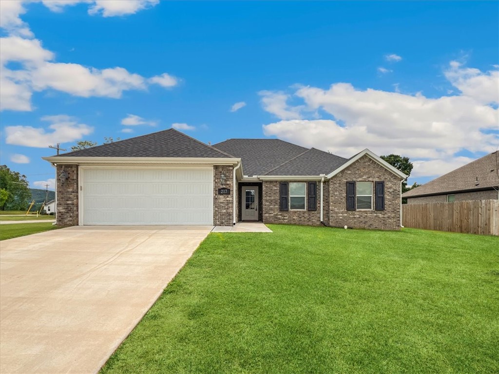 Beautifully maintained 3-bedroom, 2-bath home in Wagon Wheel Crossing. Built in 2022, this modern 1,587 sq ft residence features an open, split floor plan highlighted by cathedral ceilings, luxury vinyl plank flooring, plush carpeted bedrooms, and stylish granite countertops throughout. The spacious eat-in kitchen offers stainless steel appliances including gas range, microwave, dishwasher, refrigerator, pantry, and ample cabinetry. Relax in the living room, showcasing a cozy gas-log fireplace and impressive cathedral ceilings with exposed wood beams. The primary suite provides a luxurious retreat with a jetted tub, separate walk-in shower, and two generous walk-in closets. Home amenities include blinds, ceiling fans, covered patio, washer/dryer connections, architectural shingles, attached 2-car garage, and a large 0.28-acre cleared lot with curbing. Ideally located near Farmington schools, shopping, and easy highway access.