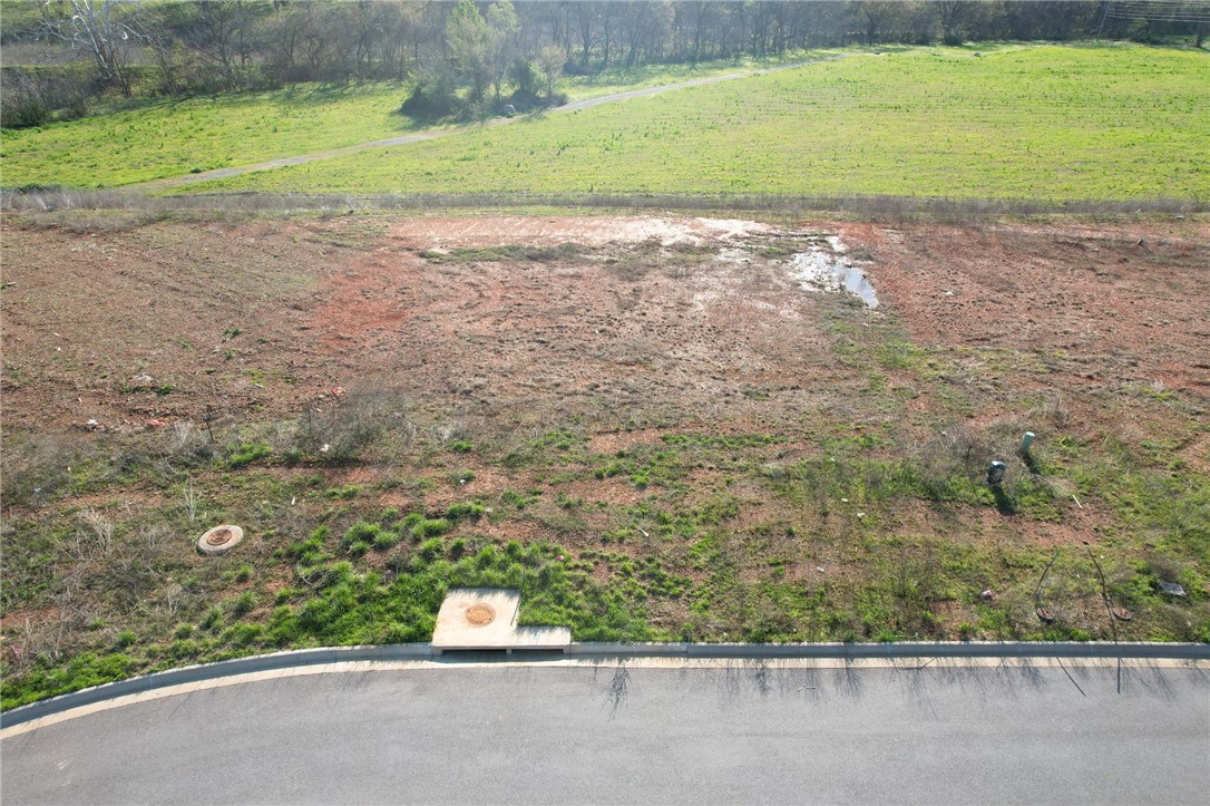 Exceptional multifamily development opportunity at the epicenter of Northwest Arkansas's explosive growth. This lot is ready to build on with roads and infrastructure complete. This strategically located property sits within one of the nation's most dynamic markets, where over 40 people move to NWA daily in 2025. As Walmart's headquarters and home to Crystal Bridges Museum, Bentonville offers world-class amenities, premier mountain biking trails, and a thriving downtown square. The multifamily market is positioned for steady growth driven by robust economic fundamentals and sustained rental demand from workforce migration. With Arkansas being the most moved-to state and Bentonville leading as the region's economic engine, this property represents a rare chance to capitalize on unprecedented regional expansion in America's fastest-growing economic hub.