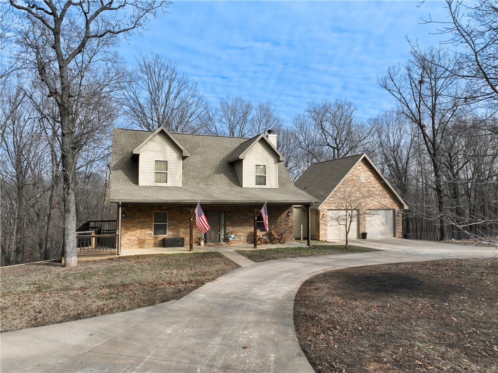 Find your way home to this spacious 5-acre Retreat on the Edge of Gravette. Experience the perfect balance of country living and convenience in this stunning 3-bedroom, two-full, two-half bathroom home with 3,005 sq. ft. of living area.
Nestled on 5 acres just outside of the city, this property offers a true retreat while keeping you close to everything Northwest Arkansas has to offer and less than 30m to the new Walmart home office.
It features a safe room, an expansive bonus/living room, and an oversized detached two-car garage with an office above it. Cozy up by the wood-burning fireplace, relax on the front porch, or unwind on one of the decks while soaking in the quiet serenity of country living. Escape the ordinary and come home to what feels like your own private lodge.
Just 1.5 miles from the high school and 5.8 miles from I-49, enjoy quick access to everything NWA offers. New HVACs: 4-ton (2023) & 2-ton (2024). New stove/oven (2024). Dishwasher, microwave, and water heater (2020 or newer).