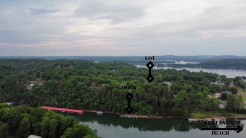 Rare find! BOAT SLIP included! 3 separate lots, all next to each other, in the desirable Beaver Shores subdivision WITH one boat slip in a co-owned dock with only 6 slips (10x20)! This is one of the neighborhoods around Beaver Lake that allows short term rentals & has very few restrictions! The neighborhood has 2 boat launches as well as a nice beachy area by the main boat launch for parking. The lots are close to the main boat launch in subdivision. Less than 10 minutes to Downtown Rogers! Close to Prairie Creek marina, restaurants, Dollar General & grocery stores. Build 3 lake cottages for Airbnb income or one large lake house. Lots of possibilities! Septic permits already approved by the county but have expired so will need to be updated. Water & Electric at street. Survey available upon request. Owner/agent