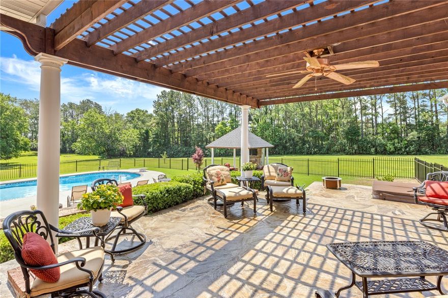 Gorgeous estate home on just under 5 acres in Rogers, featuring an immaculate colonial-style main house, full guest suite, and heated saltwater pool. This 5,932 SF home offers multiple living spaces & 4 bedrooms with private baths. Home office, formal dining room, and spacious kitchen with abundant cabinetry, an island, pantry, and eat in area with fireplace. Formal living room includes raised ceilings, a fireplace, large windows and patio access, while a living room on main level adds extra gathering space. Primary suite boasts a fireplace, sitting area and a luxurious attached bath. Upstairs are two guest bedrooms with baths and walk-in closets and 2 bonus rooms ideal for media or game spaces. A breezeway leads to the guest suite with full kitchen and bath. Outdoors, enjoy the patio, pool and gazebo with fireplace, surrounded by lush landscaping. Updates include a new roof (2020), HVAC & water heater (2018) and pool liner (2023). Sought after location near Pinnace & Pleasant Grove shopping, dining, entertainment.