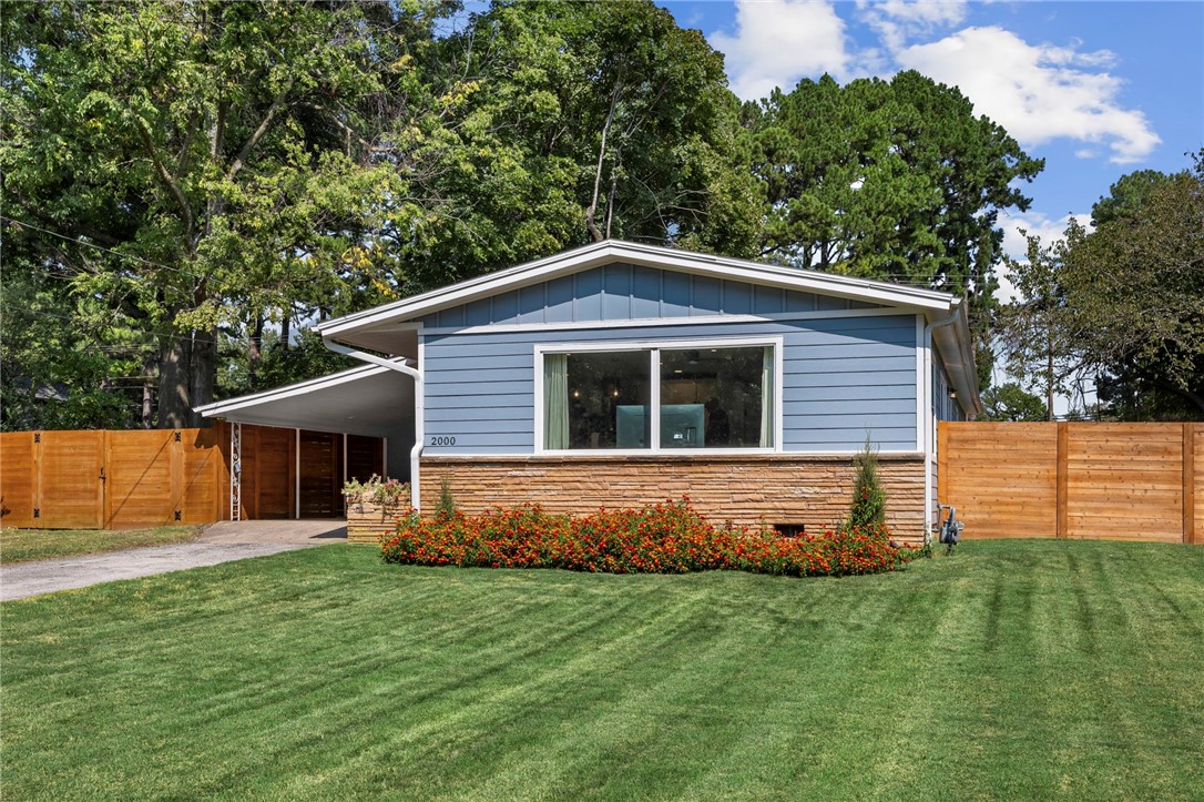 Get ready to call those Hogs & enjoy one of Fayettevilleās most beautifully renovated mid-century modern homes. This game-day ready 3-bed, 2-bath home is less than a mile from the University of Arkansas & just a short walk to Asbell Elem. The open-concept design features original refinished hardwood floors, abundant natural light, & a seamless flow between living room & kitchen. The fully redesigned kitchen offers butcher block counters, open shelving, custom backsplash & new stainless steel appliances perfect for feeding the entire team! A new 450 sq ft addition creates a spacious primary suite with a huge walk-in closet & spa-like bath including a soaking tub & separate luxury shower. Updates include new electrical, HVAC, roof, and energy-efficient windows. Outside, enjoy a covered carport, large fenced yard, new concrete patio ideal for tailgates, horizontal privacy fence, and mature trees. Move-in ready and thoughtfully updated, this home offers comfort, style, and location. Be on Hwy 49 in less than a minute!