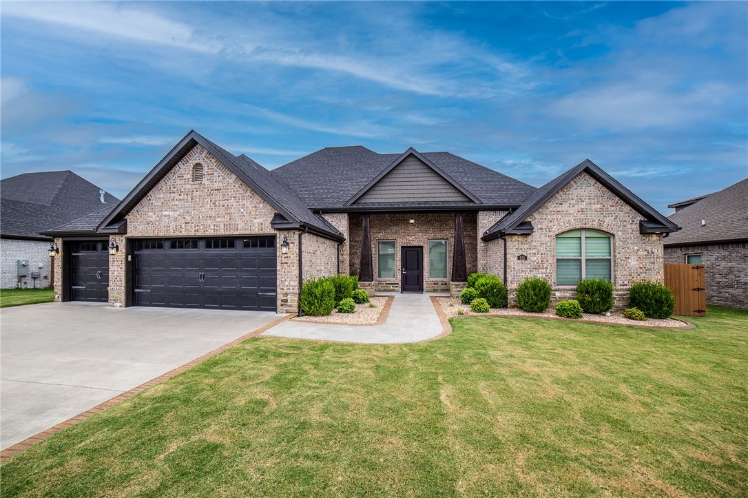 Discover upscale living in this exceptional home built by Cornerstone Construction, ideally situated within walking distance of Bentonville West High School and Gamble Elementary. This 4-bedroom, 3-bathroom residence is filled with high-end features and amenities that are sure to impress. The living area is anchored by a beautiful fireplace and vaulted ceiling with custom beam, while the chef's kitchen offers a large island, an oversized hidden pantry, gas range, and custom cabinetry. Every inch of this home is thoughtfully designed, with gorgeous hardwood floors flowing throughout the main living areas and the primary bedroom. Step outside to a fully landscaped yard, easily maintained by a built-in sprinkler system and curbed landscaping borders. Additional features include energy star certification, LED lighting, a tankless water heater, central vacuum, wireless security and surround sound systems, soft-close cabinetry, exterior uplighting, Christmas light outlets, and more.