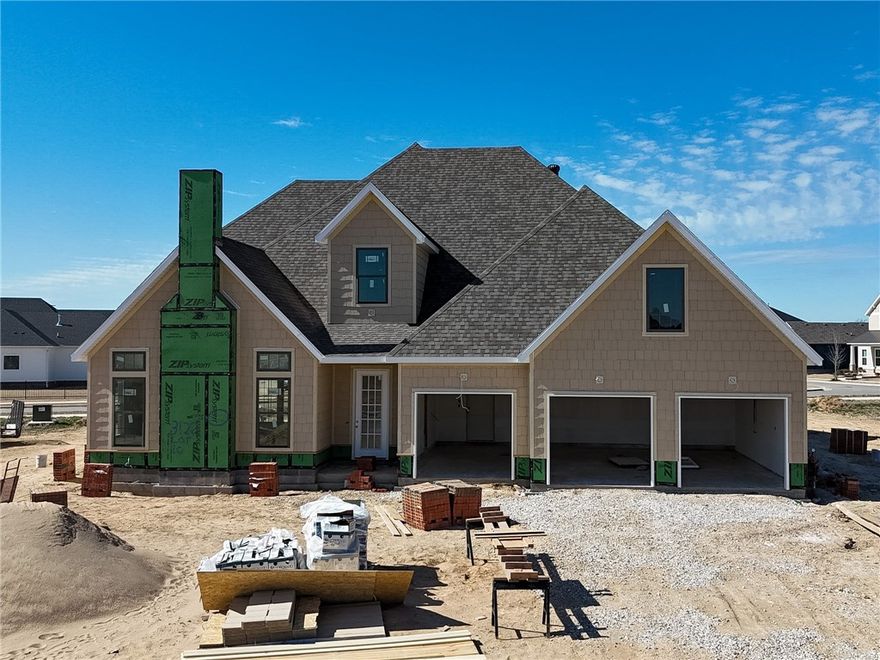 Welcome to County Line Square, a new Springdale community near Shaw Family Park with a pool and pavilion. Upon entry, the living room sits just to the left and features a vaulted ceiling, a brick fireplace, and engineered hardwood floors that extend throughout the first floor. This space opens into the dining and kitchen area, where sliding glass doors lead to the covered back patio. The kitchen includes a large island, quartz countertops, cabinets to the ceiling, GE Profile stainless steel appliances, and a pantry. Down the hallway, you’ll find access to the 3-car garage, the laundry room, a guest bedroom, a full bathroom. The primary suite is also on the main level and features a vaulted ceiling, along with a bathroom that includes a double vanity and centered makeup vanity, a walk-in shower, and a walk-in closet. Upstairs offers 3 additional bedrooms and a full bathroom. A fence, blinds, and gutters are included. Builder’s preferred lender is offering $3500 toward closing costs or a rate buy down. *Agent Owned*