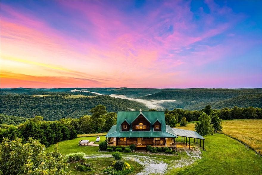 Here's your chance to own this rare Newton County property with 550+/- acres having a nice mix of pasture, hardwoods, a spring and spectacular mountain sunset views from your custom-built Log Cabin, AND one of the renowned "Mountain Springs" natural springs supplies fresh water to the home. This unique property offers 3 bedrooms, an office, 2 baths, an open floor plan highlighted by vaulted ceilings and a stunning catwalk that separates the upstairs bedrooms. Enjoy year-round outdoor living on the wraparound covered porch, where you can take in spectacular long-distance mountain sunset views or relax in the hot tub under the stars. Equestrian enthusiasts will appreciate the horse barn and pasture with fabulous trails to ride nearby. Bring your convertible and ride the scenic mountain highways because the drive is asphalt, leading from a state highway. There's a 24 X 30 carport attached to the home. Selling furnished and with appliances and hot tub conveying!