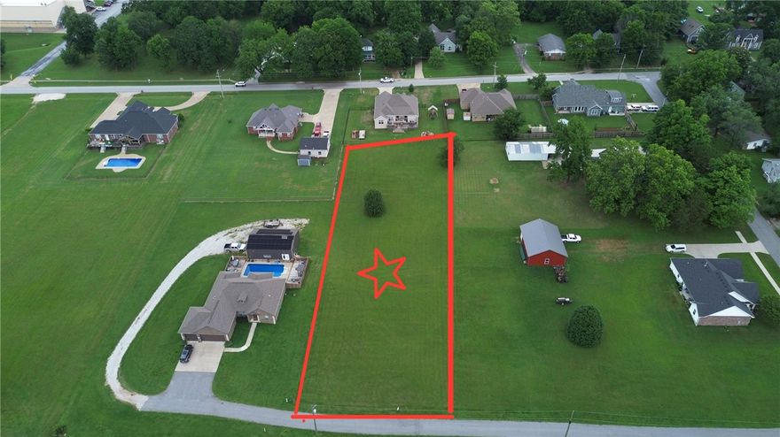 Location, privacy and eye appeal all make this nearly one-acre lot an ideal spot to build your home!  In the middle of Prairie Grove within walking distance of downtown and high school, yet secluded down a private paved driveway with a great view to the south!  All utilities available at the street.  Let your imagination go and this can be your own paradise!  Plenty of room for a shop or a pool - or both!  You better look at this .96 acre parcel - hard to find better at this price!  And, you are extremely close to schools, shopping, water park, ball fields, etc.