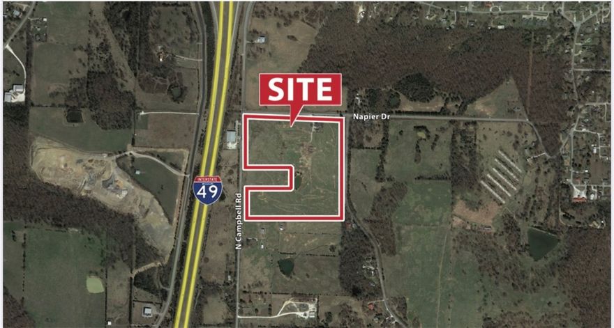 35 Acre tract with commercial and/or development potential. High visibility from I-49! Square tract, with the exception of a 4 acre "cut-out" and small cemetery. Existing structure on-site holds no value. Property is bounded by 3 streets. Approx. 4 miles to Fayetteville and 30 miles to Bentonville.