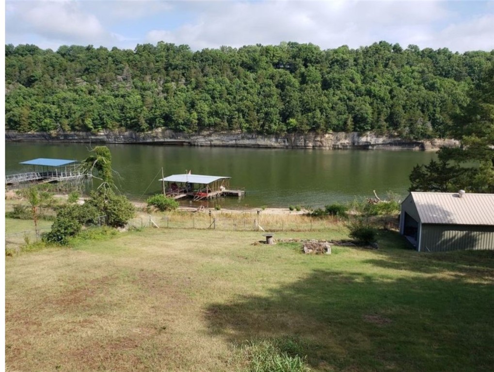 Lake front property with an incredible view of Beaver Lake and rock bluffs. This property would make a great primary or weekend home and is a quick drive to Hwy 412. Updated with granite counters, new kitchen appliances, flooring, and updated bath. Three slip dock is co-owned with neighbors.
SOLD BEFORE PRINT
