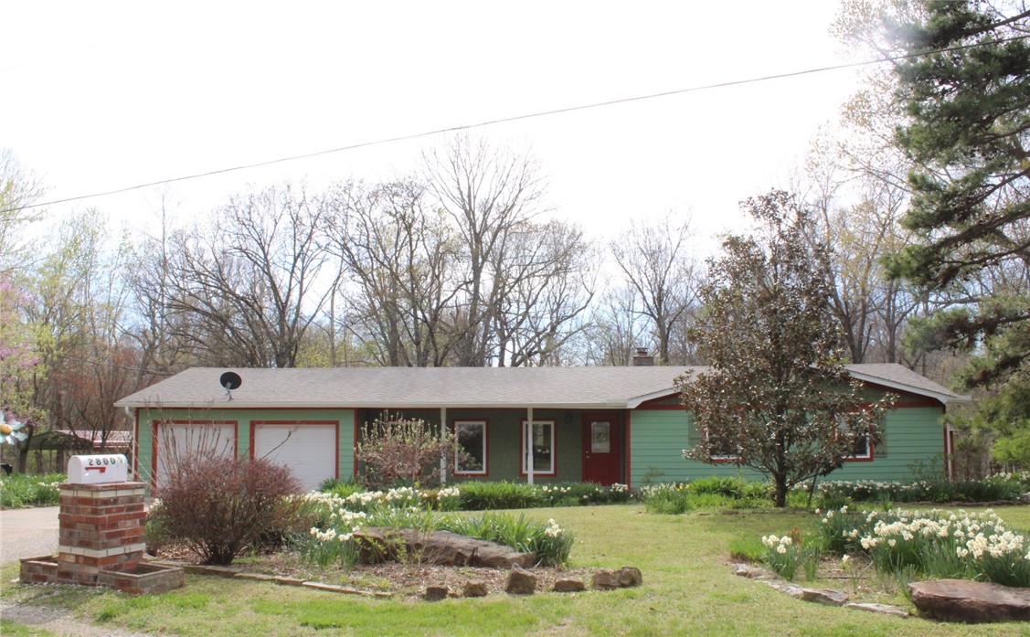 What a lovely setting on 2.41 acres! Large LEVEL yard area & wooded view! Home has a
Spacious Living/Dining room combination, Large Family room, a bright pretty SUNROOM
overlooking the woods and a functional "U" shaped Kitchen with QUARTZ counters. Updates include: newer quality PELLA windows, new ROOF 2022, septic pumped 2022. 2 nice outbuildings too!
Parking is a 2 car attached garage AND a large detached 20' x 20' carport - great covered parking for a boat or other vehicle! Pretty gardens front and rear and a vegetable garden area! Master bedroom is very spacious & opens to a rear deck! Beautiful New electric FIREPLACE in the Living room. The custom mantle is removable if desired. Corner location lends to more privacy in a serene setting. Nicely maintained home with solid surface flooring throughout. Located in the COUNTY (with Rogers mailing address) so very few restrictions! This is a probate sale - Seller may accept an offer & then it is subject to court approval (estimated to take 7 bus.days approx.)