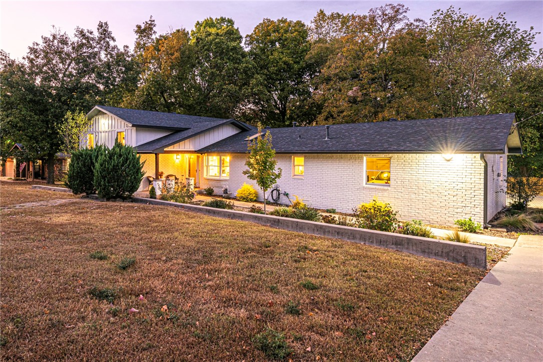 WELCOME! This Tri-Level 4 bed 3.5 bath is in a premier location min away from Lake Fayetteville, Springdale Country Club, Downtown Springdale & more! This renovated home w lots of curb appeal & garden pathways to the covered front porch! Head inside to the sunken living rm with REFINISHED HARDWOOD FLOORS & lots of natural lighting! Kitchen feat: NEW granite counters, NEW backsplash, skylight, & built-in granite breakfast bar! Upstairs relax in the primary bedrm w private ensuite feat: double sink vanity & shower! 2 more bedrms & full bathrm upstairs! Downstairs a 4th bedrm for guests w bonus rm for office/gym/etc & 3rd Full bathrm! 2nd living rm w wood-burning stone fireplace, kitchenette, & wall of windows to enjoy your oasis! Outside, a lower level patio & upper level deck overlook the fenced in yard w mature trees! Wired for hot tub 10x12 shed! MORE: Oversized Anderson windows, New granite in bathrooms, New Light fixtures & ceiling fans throughout, New roof, new exterior paint, new Hardie Board & Batton in 23'