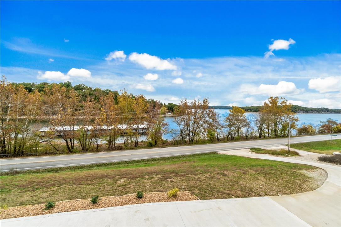 Rare opportunity to own a .53-acre buildable lot just before the Hwy 12 bridge, only minutes from Downtown Rogers and Beaver Lake with public boat access nearby. Perfect for lake lovers and outdoor enthusiasts, this parcel offers both convenience and serenity in one of Rogersā most desirable settings. Located adjacent to the Cliff House residence at 16103, this lot features a shared driveway providing easy access for both properties. The seller has already completed excavation and septic planning, making the site ready for construction. If the lot remains unsold after 16103 closes, the seller plans to build a custom home and infinity pool as shown similarly in the marketing images ā giving buyers the choice to purchase now and build their own dream home, or see the property transformed into a stunning new residence in the future. A rare find near Beaver Lake, offering exceptional build potential close to restaurants, amenities, and all that Downtown Rogers has to offer. Also listed under MLS #1326748.
