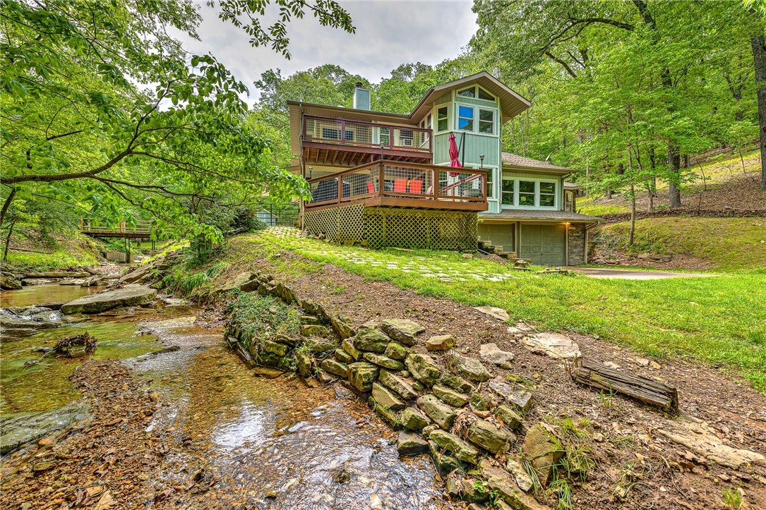 Motivated Seller!!! Are you looking for a secluded/private lake retreat? This is the one! Lakefront home on 10 acres & just 5 miles from downtown Rogers, AR. New roof as of June 2024. This home is currently on a short-term rental program and being sold completely furnished, so if you are looking for an investment opportunity it is ready to go or if you want it as your private residence, it is ready for this also! Property sits on a quiet cove, fed by a year-round creek just around the bend from Prairie Creek Marina on Beaver Lake. It is a short level walk to lake access. No drive by viewings as you cannot see the property from the street. This property is not in a subdivision and there are NO restrictions on the use of the property. This home has been completely updated. New roof installed June 2024. To view the web listing for the short-term rental, Google – Tranquility Cove Beaver Lake. Call to schedule a showing today.