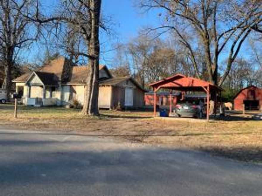Seller has reduced the sales price to offset the cost of some of the repairs. The new owner will own the entire Block.  Buyer could have a new roof, new windows and new siding all the way around the house for under 10k per estimate provided to seller.Nice Barn with Stalls that could easily be converted to a shop!Seller has done most of the hard work.All thats left is to move in and finish it up and reap the rewards!!Seller has updated plumbing, electrical, faucets,tub,shower,commode,sheetrock,flooring, hot water heater and more. No Restrictions!