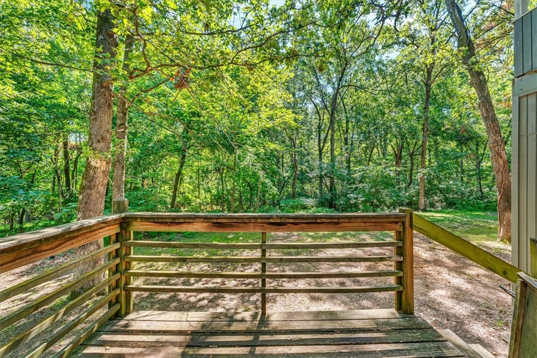 Tree huggers dream! Have you been looking for a quiet spot near everything Fayetteville with room to breathe? This acre+ lot on a peaceful cul-de-sac could be the one! Unique floor plan with bedrooms and laundry downstairs with living area, kitchen, and covered deck upstairs makes you feel like you are on vacation every day. Located in the desirable Hidden Acres area next to Clear Creek, this property offers a rare opportunity to have space where you can embrace nature. Come chill!