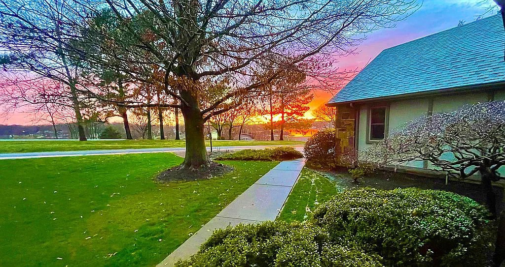 Ideal LOCATION steps from Lakepoint Restaurant & Wine Bar and Lake Loch Lomond Marina!
Shopping areas are nearby, as well as the bypass for easy access to Bentonville & Rogers shopping! Enjoy gorgeous sunsets & LAKE VIEW from the inviting front porch. Home has many updated and delightful features! Open Living/Dining area has vaulted ceiling, hardwood floors and a central wood burning Fireplace with marble surround. Kitchen/Nook features include slate tile floors, stainless steel appliances, desk area & granite counters. The Primary bedroom suite has a beautiful view of the woods and leads to the lovely covered deck. Additional deck area is open for a BBQ ! Primary bathroom has jetted tub, dual vanities, separate shower & walk in closet. 2nd bedroom is used as an office/media room and the 3rd guest bedroom is quiet and private in this split bedroom floorplan. Laundry off kitchen also has a pantry! Concrete area in basement can be for a golf cart, storage or Workshop! Furnishings can be purchased separately too!