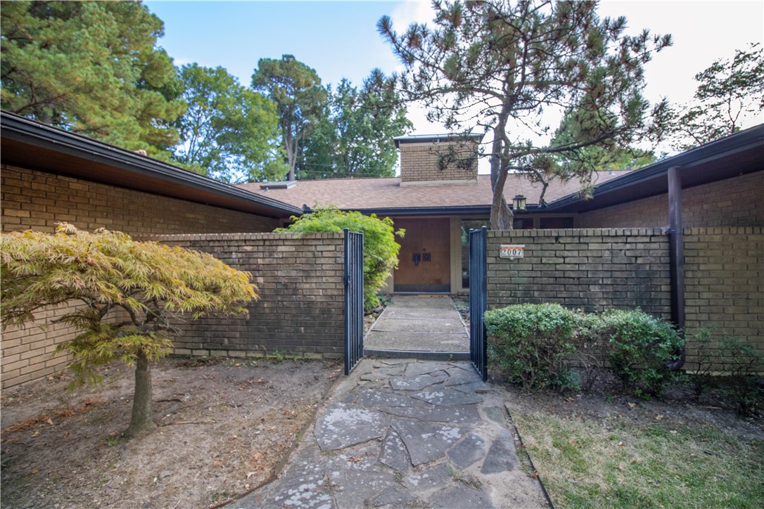 Calling all mid-century enthusiasts! Designed by Fay Jones protĆ©gĆ© Tom Yost, and originally intended to be his personal home, this mid-60s ātime capsuleā features original terrazzo floors, multiple generous windows, and extensive use of Mahogony. The home echoes Fay Jonesās mentor Frank Lloyd Wright in his use of a waterfall and koi pond at the entrance, vaulted ceilings with wood beams in the living, and wide eaves as a nod to Eastern design influences. This brick 3 bed 2 bath home features the typical comforts that modern homebuyers want: 2 car garage, flat yard with mature trees on a quiet street, and large bedrooms. But it also features a few extras: a hidden wet bar opposite the fireplace in the living room, a glass enclosed back porch overlooking the pool and pool house, and generous built-ins off the kitchen. Constructed in what some have called āthe golden age of homebuilding,ā this unique piece of architecture has stood the test of time, in both quality and style. New roof in Sept 2024. 5 min from 49.