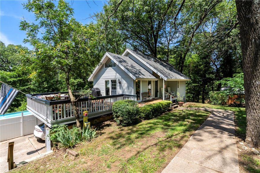 Welcome to this one-of-a-kind 5BD, 3BA, 2210SF home. The main level has vaulted ceilings, hardwood flooring, carpeted bedrooms & tile in the bathroom. The living room is filled with natural light from four oversized windows, wood beams & a wood-burning fireplace. The dining area has light streaming in from multiple windows. The kitchen has a wraparound bar, SS appliances & a trash compactor. Just off the living room, you'll find 2 BD, a full bath & a utility area. The upstairs features a loft-style living area with wood railings overlooking the floor below, a large bedroom with two closets & a full bath. The finished basement includes tile flooring throughout & carpet in both bedrooms. There's a full living area, a dedicated storage room & another full bath at the end of the hall—ideal for guests or multi-generational living. Step out onto the deck for views of the pool, plenty of storage in the 8x16 & 12x32 outbuildings. Located near schools, bike trails, a scenic park & a beautiful lake. Buyer to verify SF