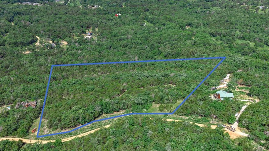 Imagine waking up surrounded by the sights and sounds of the Ozark wilderness — this is that place. Tucked away on a quiet dead-end road in the heart of Carroll County, this stunning 10.11-acre parcel in Eureka Springs offers acres of mature hardwood forest with gently rolling terrain just waiting to be explored. Whether you're dreaming of hiking your own trails, watching whitetail deer move through the timber at dusk, or simply breathing in that fresh Ozark air from your future front porch, this land delivers. Some open acreage gives you room to create while nature does the rest. No covenants means your vision rules here, getting started is easier than you'd think. This is a rare chance to own your own wooded sanctuary near one of Arkansas's most beloved natural destinations.