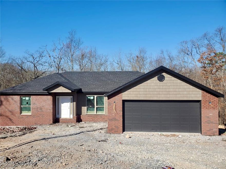 Live where adventure & comfort meet at 4 Dinton Lane in Bella Vista—the world’s mountain biking capital. Built in 2026, this thoughtfully designed home offers a split floor plan that makes daily life effortless, whether you’re hosting friends after a ride or enjoying a quiet night in. The open-concept layout showcases high-quality finishes, granite counters, a custom backsplash, & seamless flow for gathering. Retreat to the primary suite & unwind in the spa-like bath with a custom tile shower. Gutters & custom blinds are already in place for easy move-in. Set on a .40-acre lot with sewer, there’s room to breathe, entertain, or dream bigger. Minutes from the new bike park, groceries, & dining in NWA & MO—& with $5,000 in buyer incentives—this is more than a home; it’s a lifestyle. As part of the Bella Vista Property Owners Association, you’ll enjoy access to golf courses, swimming pools, recreation centers, fitness facilities, lakes, parks, & miles of trails—creating a community where every day feels like a getaway.